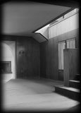 Irving Gill's Dodge House, a mid-century modern house. Black and white photo of the main stairs with wood paneling and refined modern detailing.